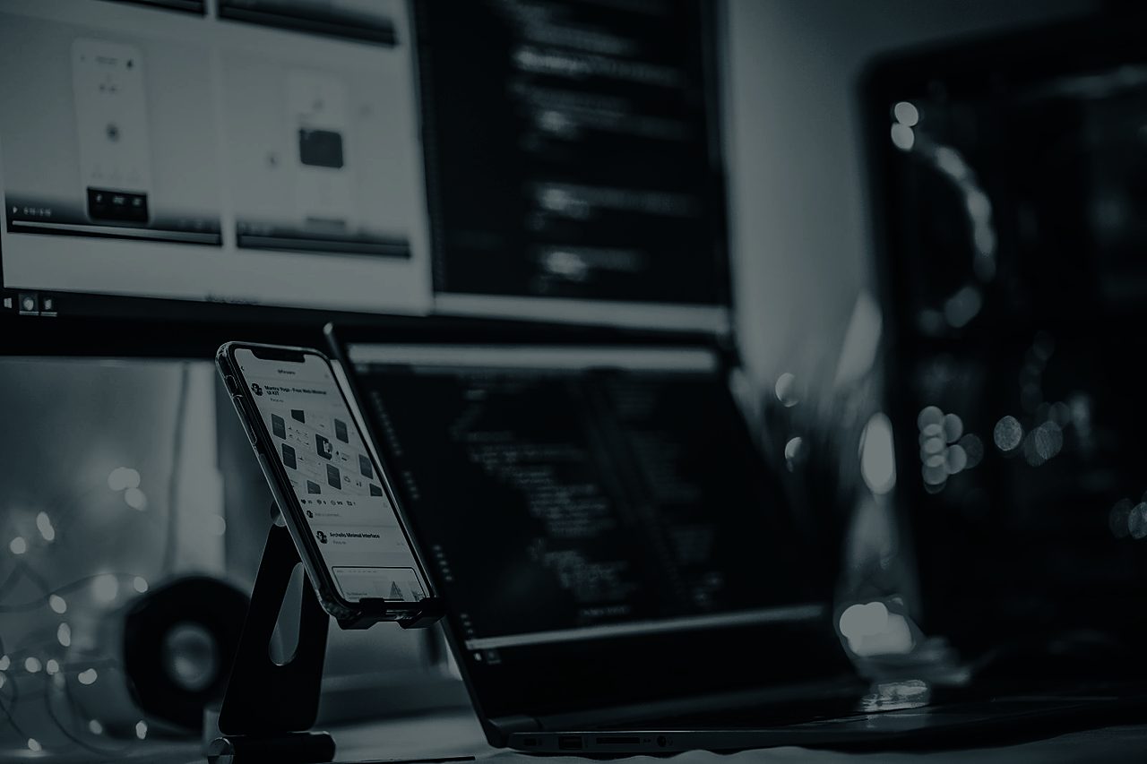 Smartphone beside a laptop during development